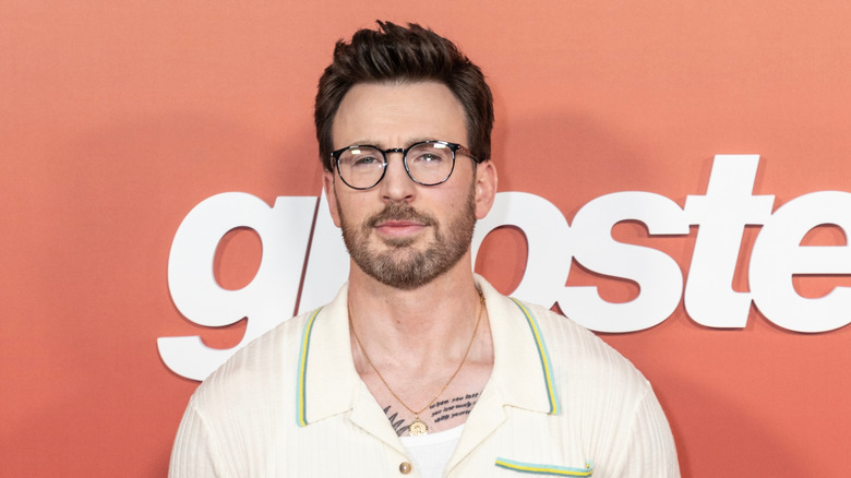 Chris Evans wearing glasses while posing at a red carpet event in 2023