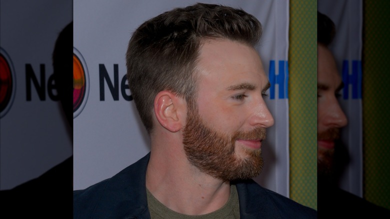 Chris Evans turning his head while posing at an event in 2019