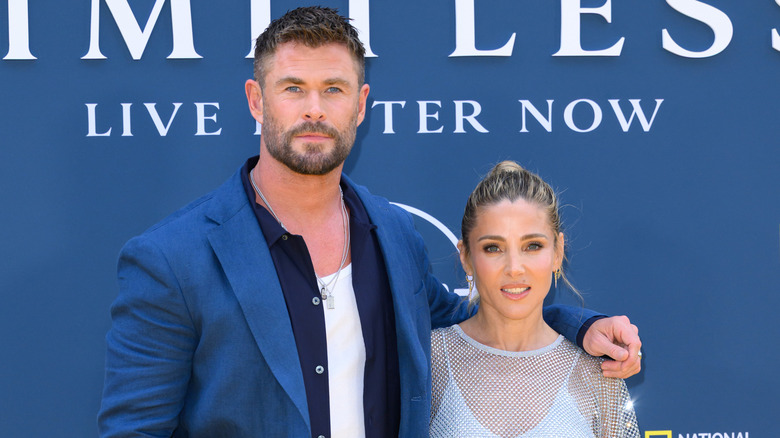 Chris Hemsworth posing with his arm around Elsa Pataky