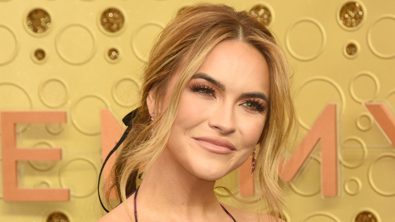 Chrishell Stause posing on red carpet with blonde hair 