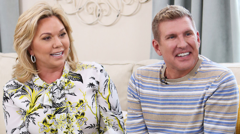 Todd and Julie Chrisley sitting on a sofa during an interview