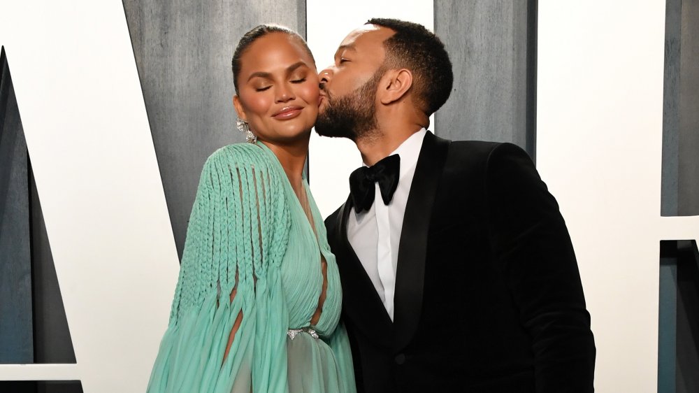 Chrissy Teigen and John Legend attend the 2020 Vanity Fair Oscar Party hosted by Radhika Jones at Wallis Annenberg Center for the Performing Arts on February 09, 2020 in Beverly Hills, California. 