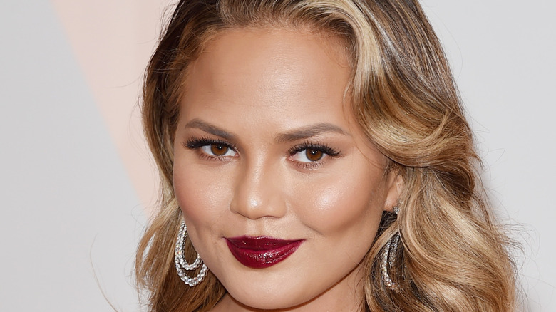 Chrissy Teigen poses on the red carpet