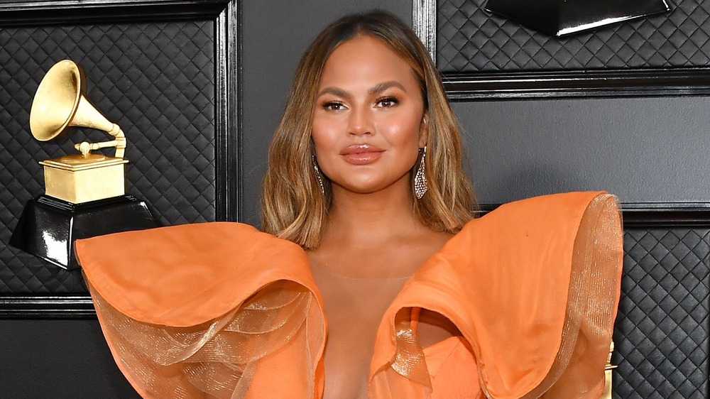 Chrissy Teigen poses on the red carpet 