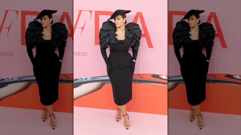 Ashley Graham posing on the red carpet at the CFDA Awards