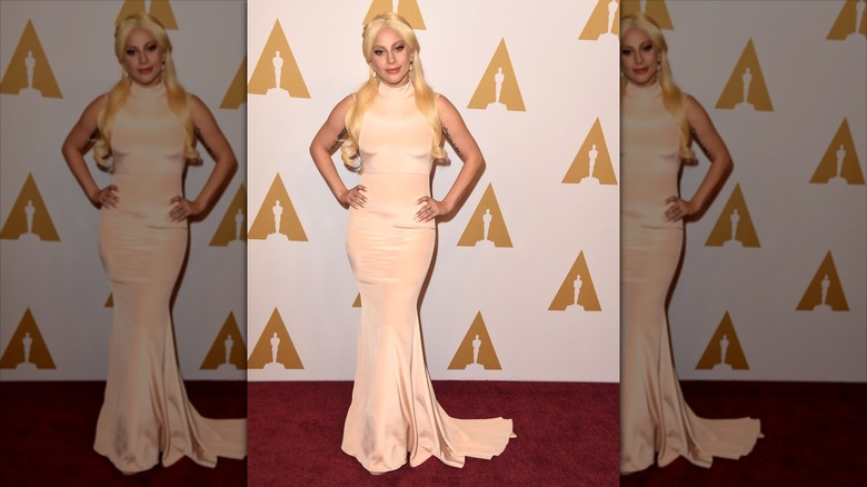 Lady Gaga posing on the red carpet at the Oscars Luncheon