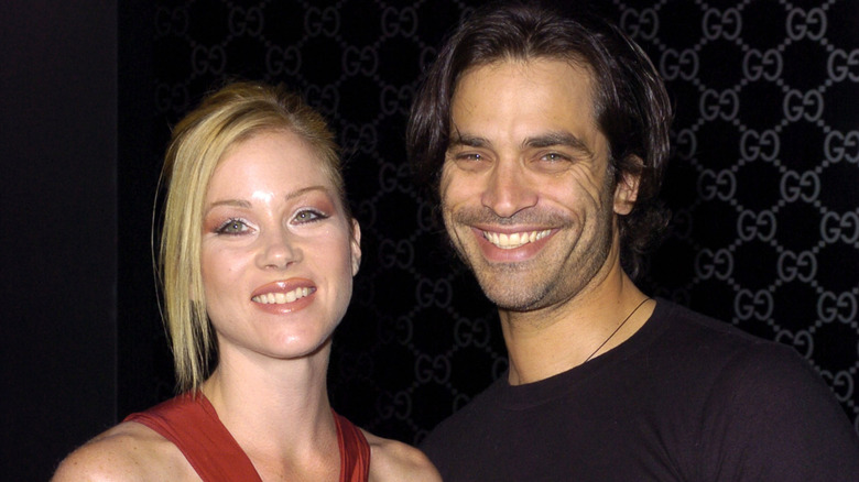 Christina Applegate and Johnathon Schaech smiling while posing at an event together