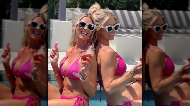 Heather Rae El Moussa and Christina Haack pose together in pink bikinis and sunglasses