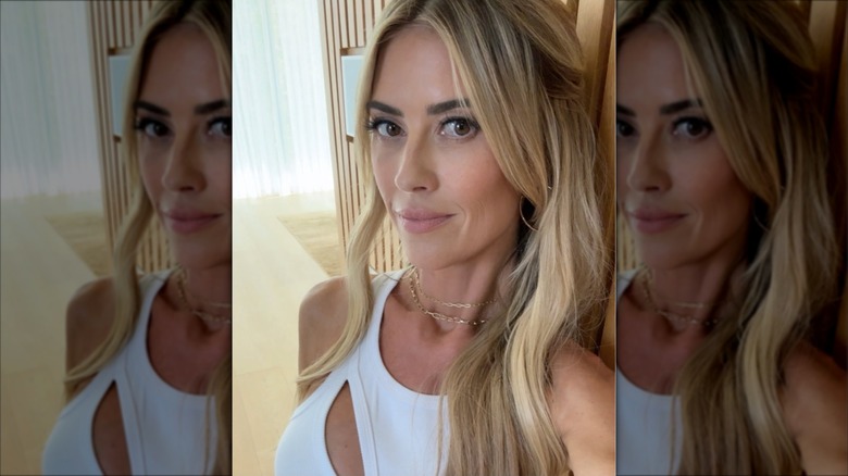 A selfie of Christina Haack in a white tank top