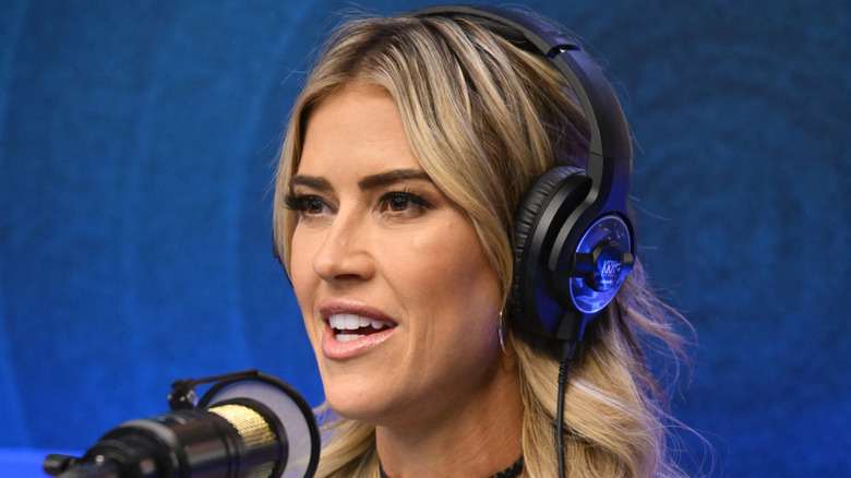 Christina Haack with headphones on speaking into a microphone