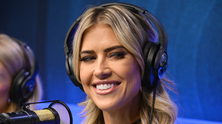 Christina Haack smiling while wearing headphones