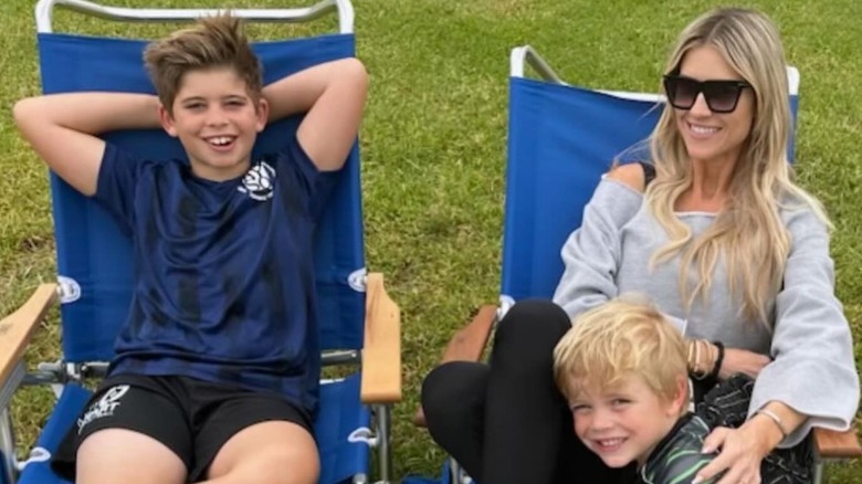 Christina Haack lounging outdoors with her sons