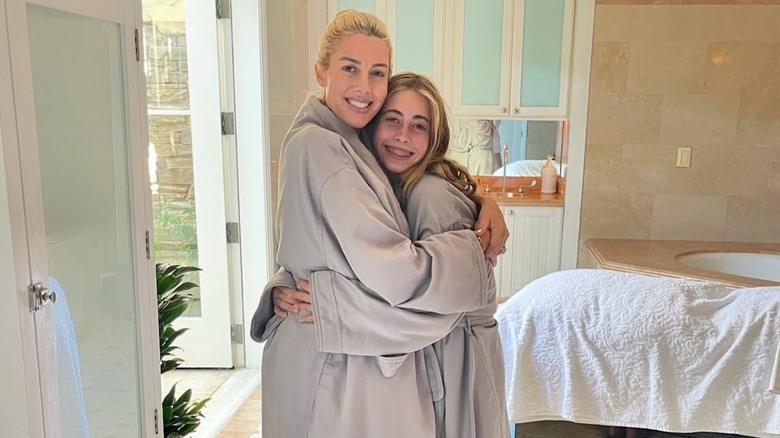 Heather Rae El Moussa and Taylor El Moussa embracing at a spa