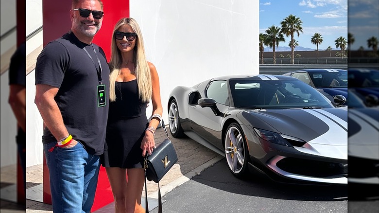 Christina Haack and Christopher Larocca pose beside a Ferrari at a racind date