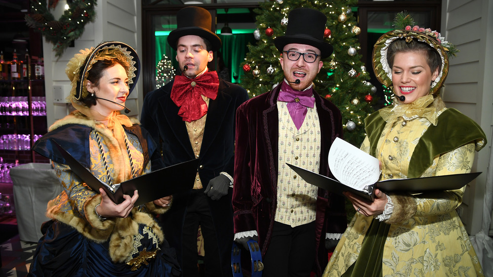 Christmas carolers in Victorian costume