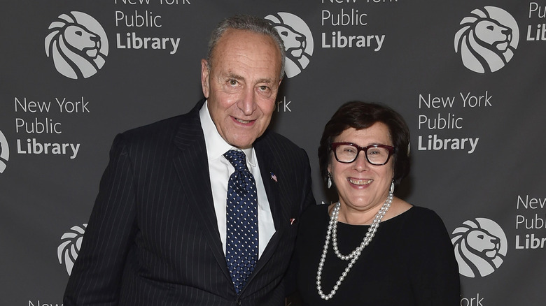 Chuck Schumer and Iris Weinshall smiling while posing together at an event