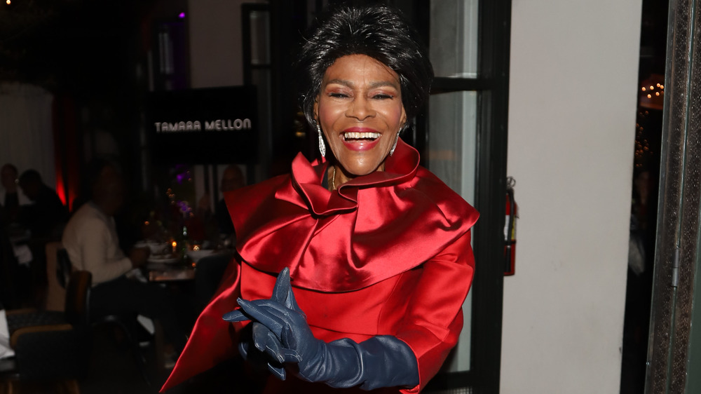 Cicely Tyson smiling in red dress and black gloves