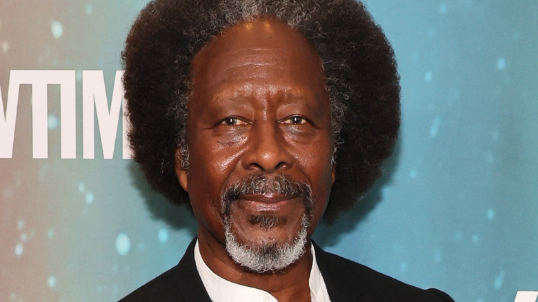 Clarke Peters in white shirt and black jacket on red carpet