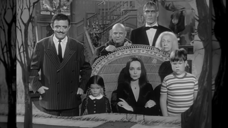 Cast of the Addams Family posing in black and white