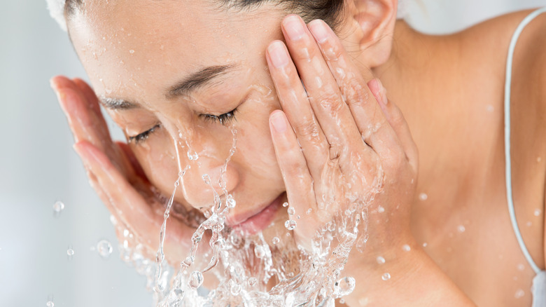 A woman washing her face 