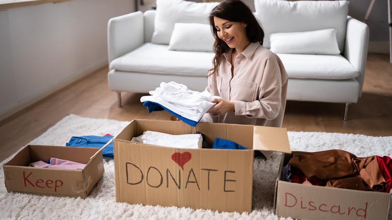 woman sorting old clothes