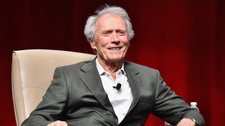 Clint Eastwood sitting in a chair and smiling