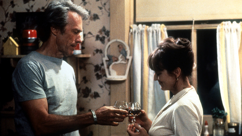 Clint Eastwood and Meryl Streep holding brandy glasses in The Bridges of Madison County