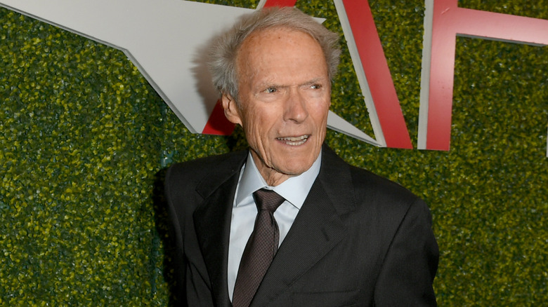 image of Clint Eastwood looking sideways and smiling on the red carpet of an event