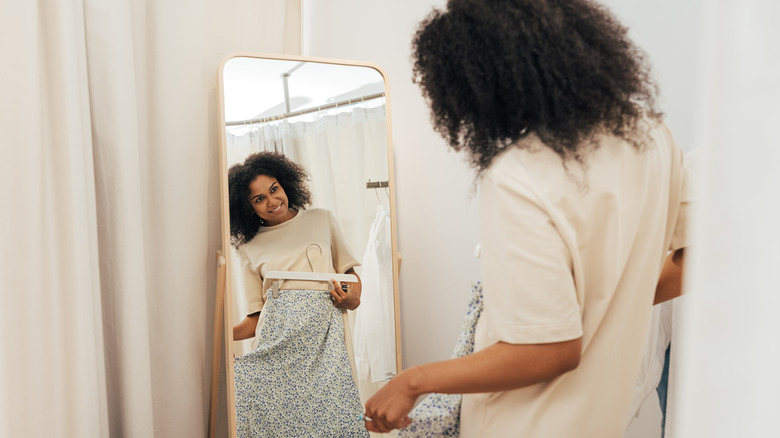 Woman trying on clothes in a dressing room in a boutique