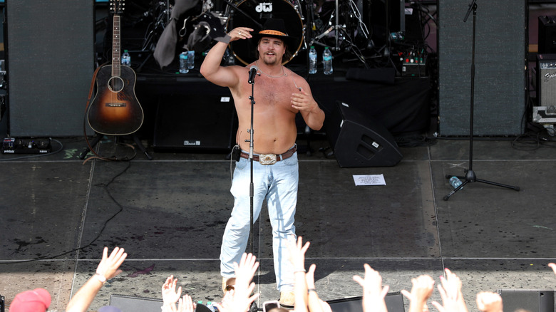 Gavin Adcock onstage in jeans and no shirt