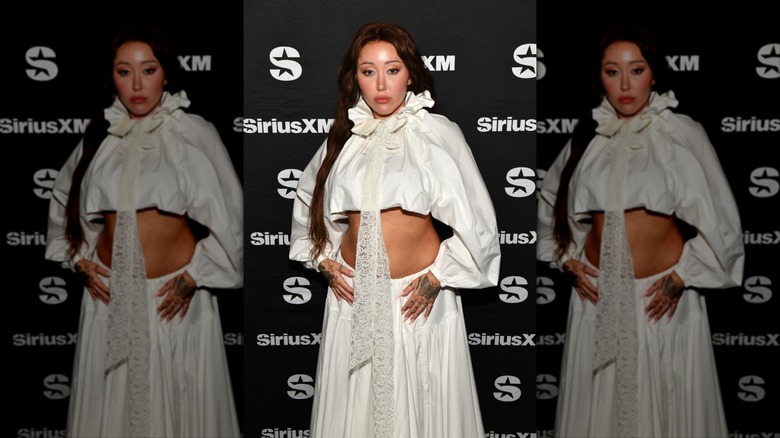 Noah Cyrus posing in white puffy outfit