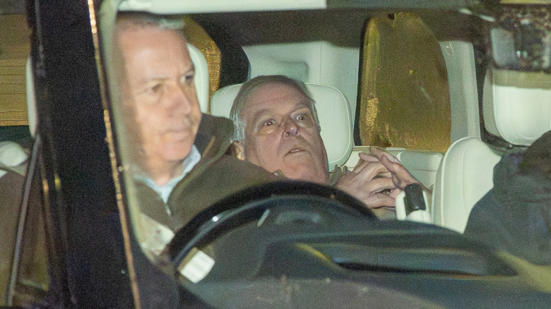 Prince Andrew seemingly ducking for cover in the back of a taxi