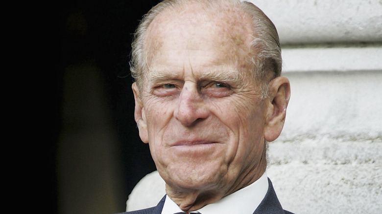 Prince Philip smiling in a suit and tie