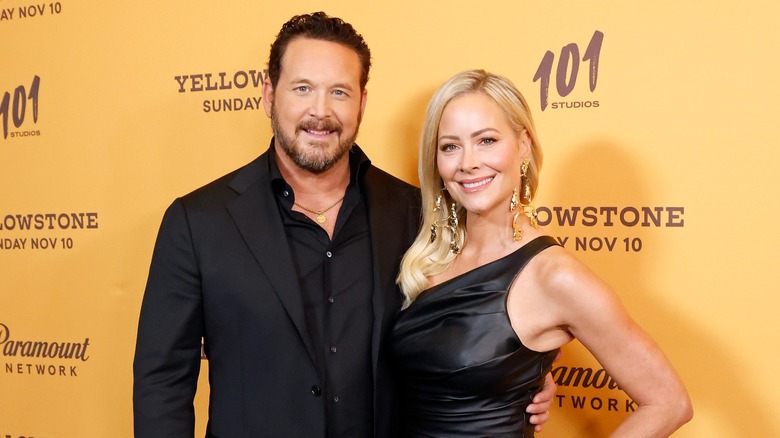 Cole Hauser and his wife, Cynthia Daniel, smiling and posing.