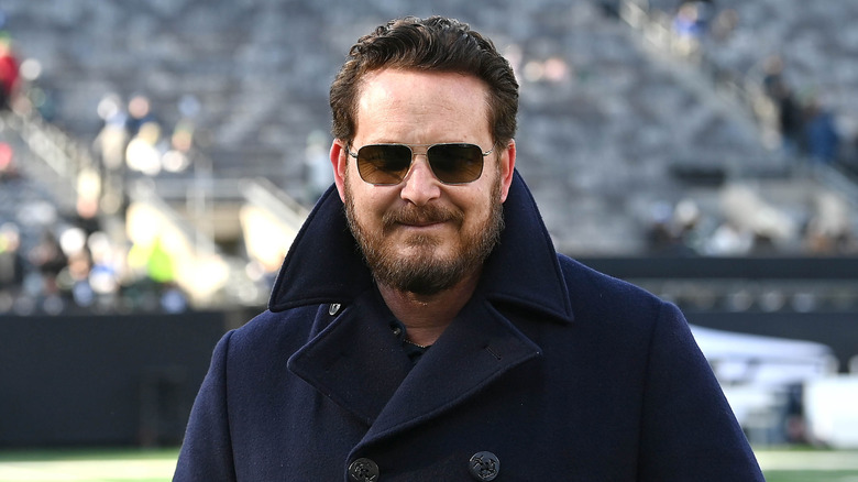 Cole Hauser smiling wearing sunglasses at a football game in New Jersey in December 2024.