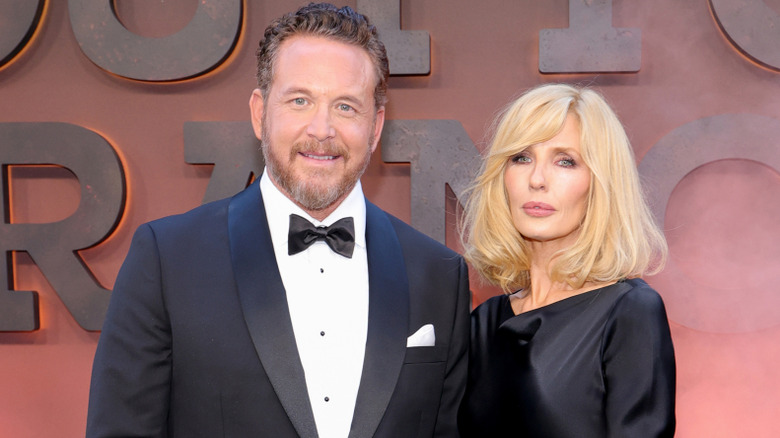 Cole Hauser and Kelly Reilly posing together in formal attire