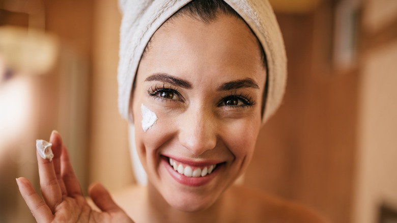 Woman applying collagen cream 