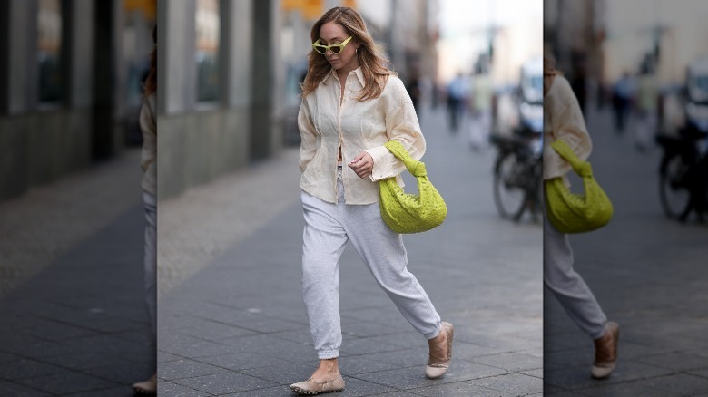 beige/white outfit with green bag