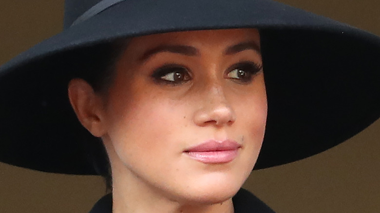 Meghan Markle looks thoughtful in a big hat