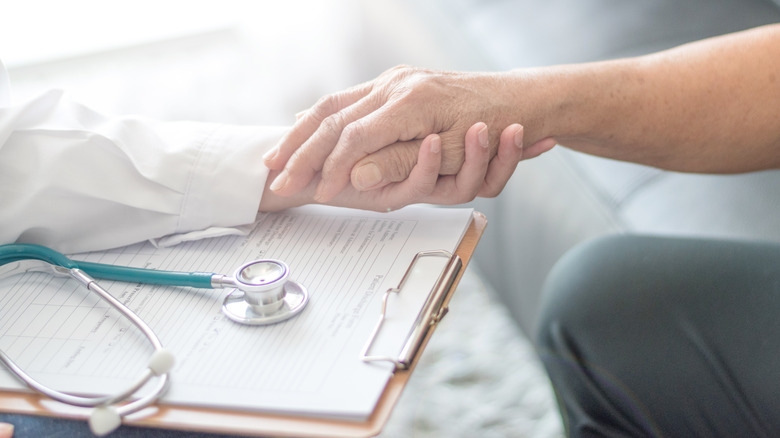 Patient being consoled by a doctor 