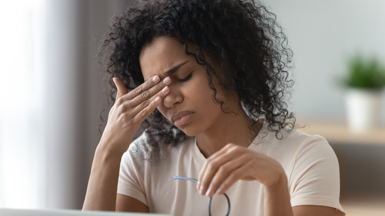 Woman rubbing her eyes