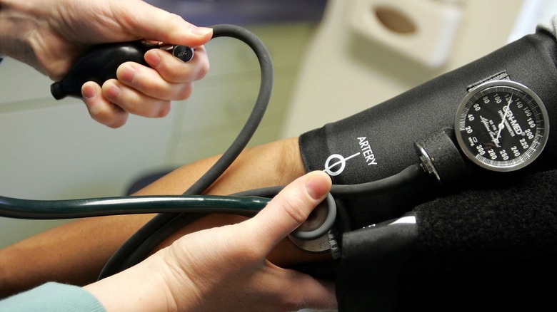 Doctor taking patient's blood pressure