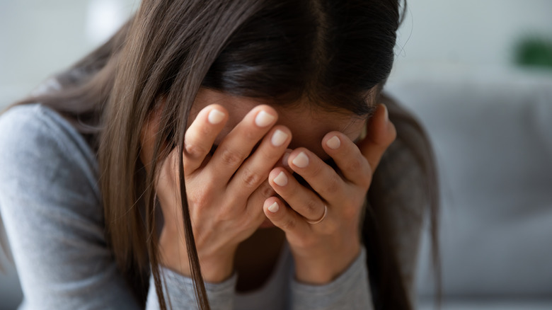 Woman with her head in her hands