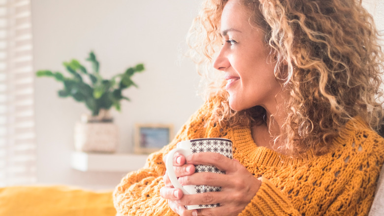 Woman smiling with a cup of tea