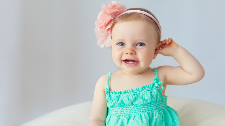 baby with ping flower in hair