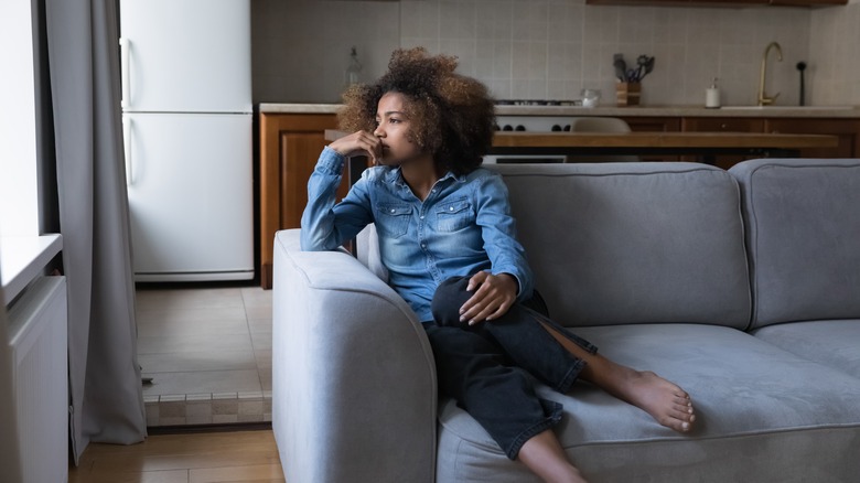 Sad woman on sofa