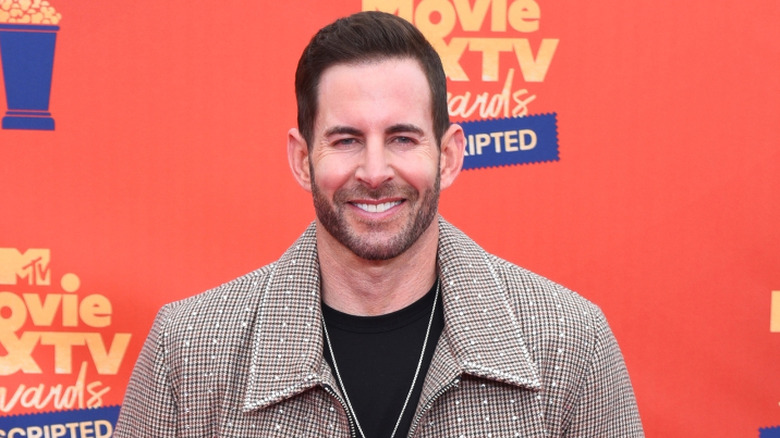 Tarek El Moussa smiling on MTV Movie & TV Awards Unscripted step-and-repeat