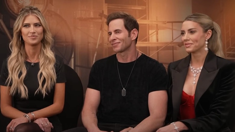 Christina Haack and Tarek and Heather Rae El Moussa sitting on a couch together during an interview