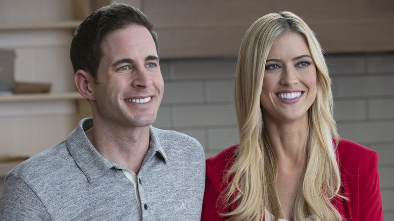 Tarek El Moussa and Christina Haack sitting together smiling on set