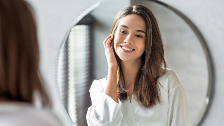 woman looking in the mirror